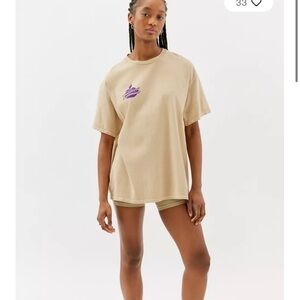 Urban Outfitters tan Graphic Tee with Purple Logo